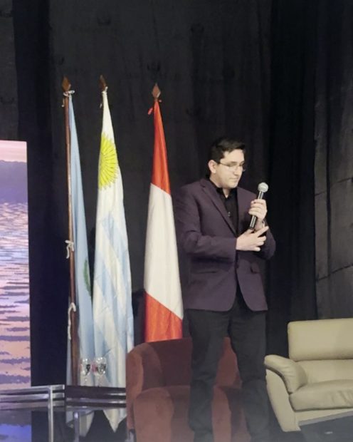 With a microphone, SKÅL Forum 2026